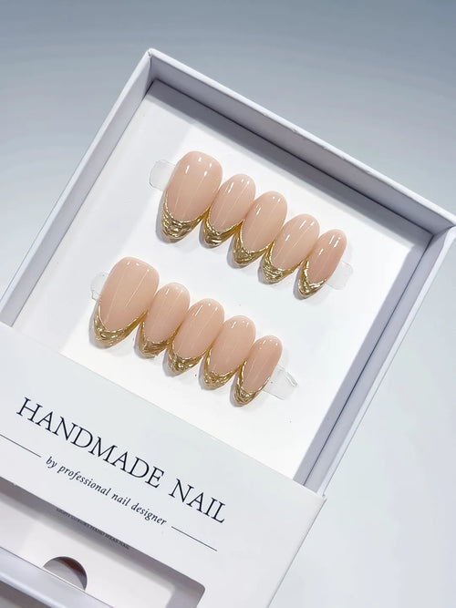 medium oval nude with gold french lines, handmade press on nails closeup