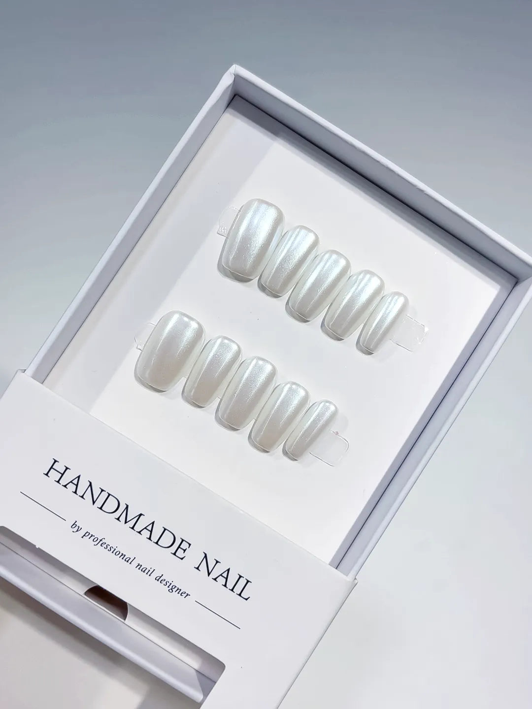 angled view of white glazed handmade press on nails with natural sheen