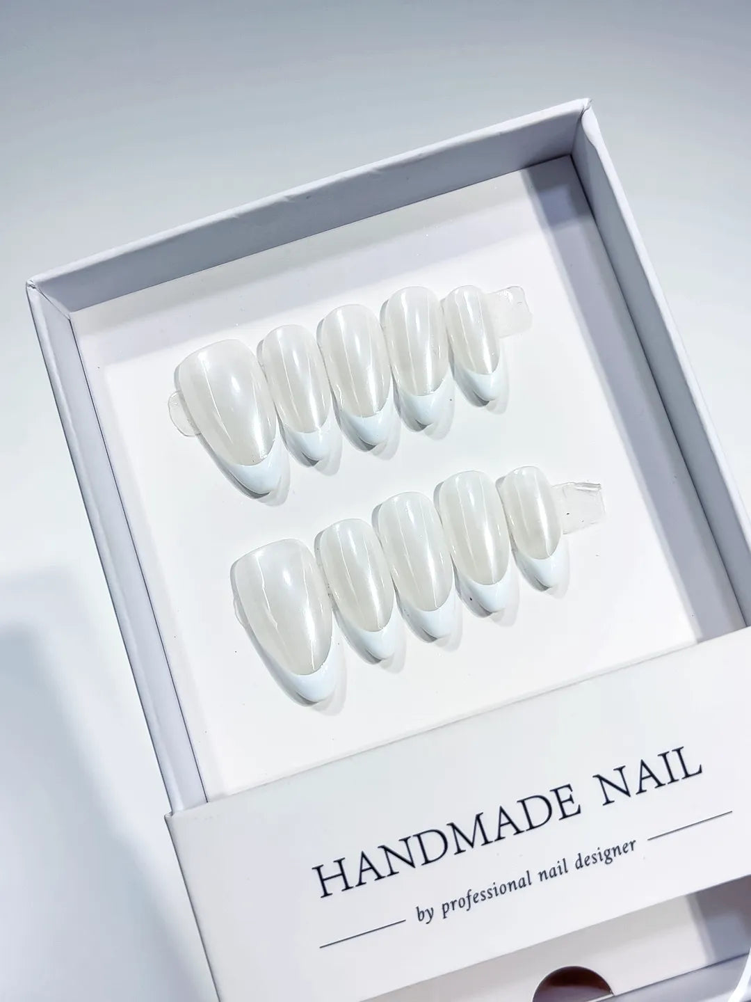 White French tip Pearl Sheen press on nails angled view