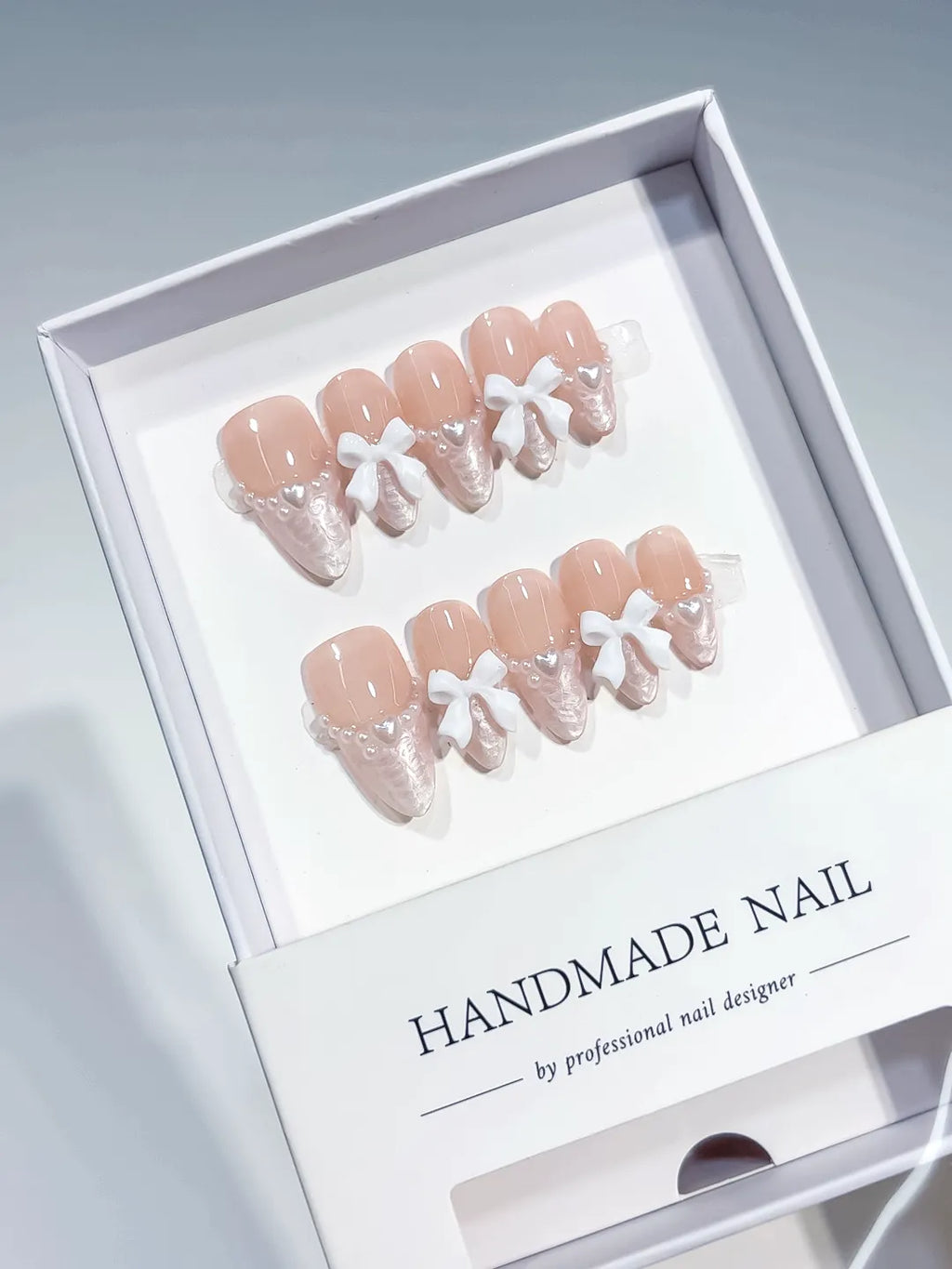 Nude White Pink French tip Bow Lace press on nails angled view