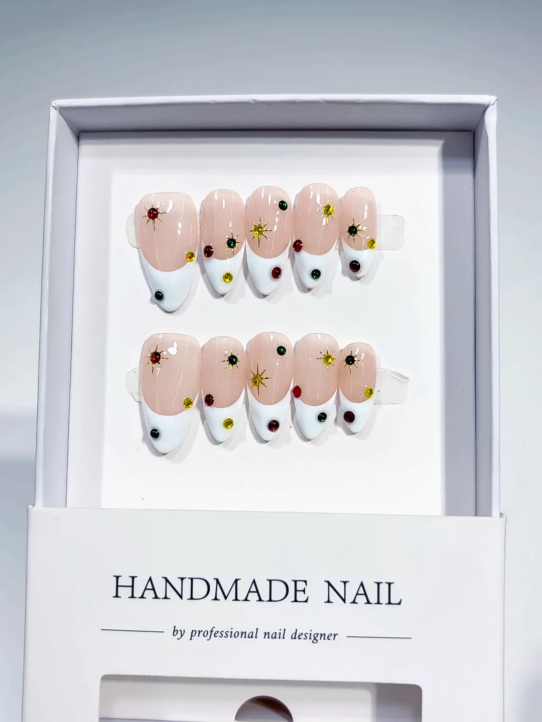 Nude White Multicolor French tip Rhinestone Starburst press on nails angled view