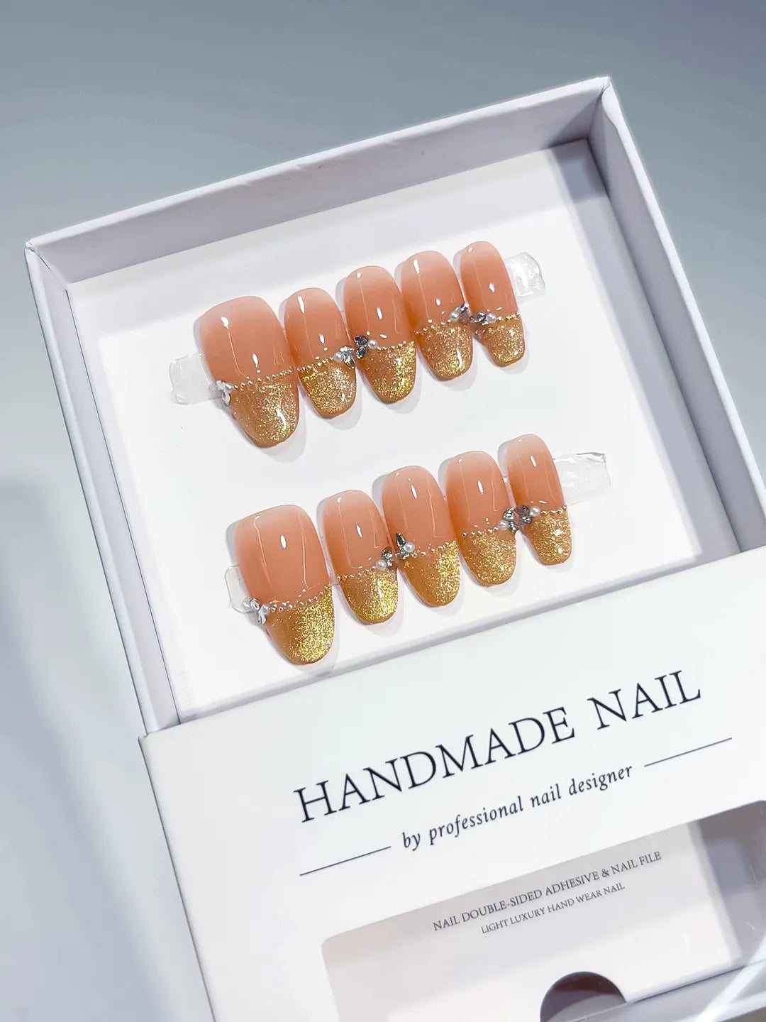Nude Gold Glitter Bow Rhinestone press on nails angled view