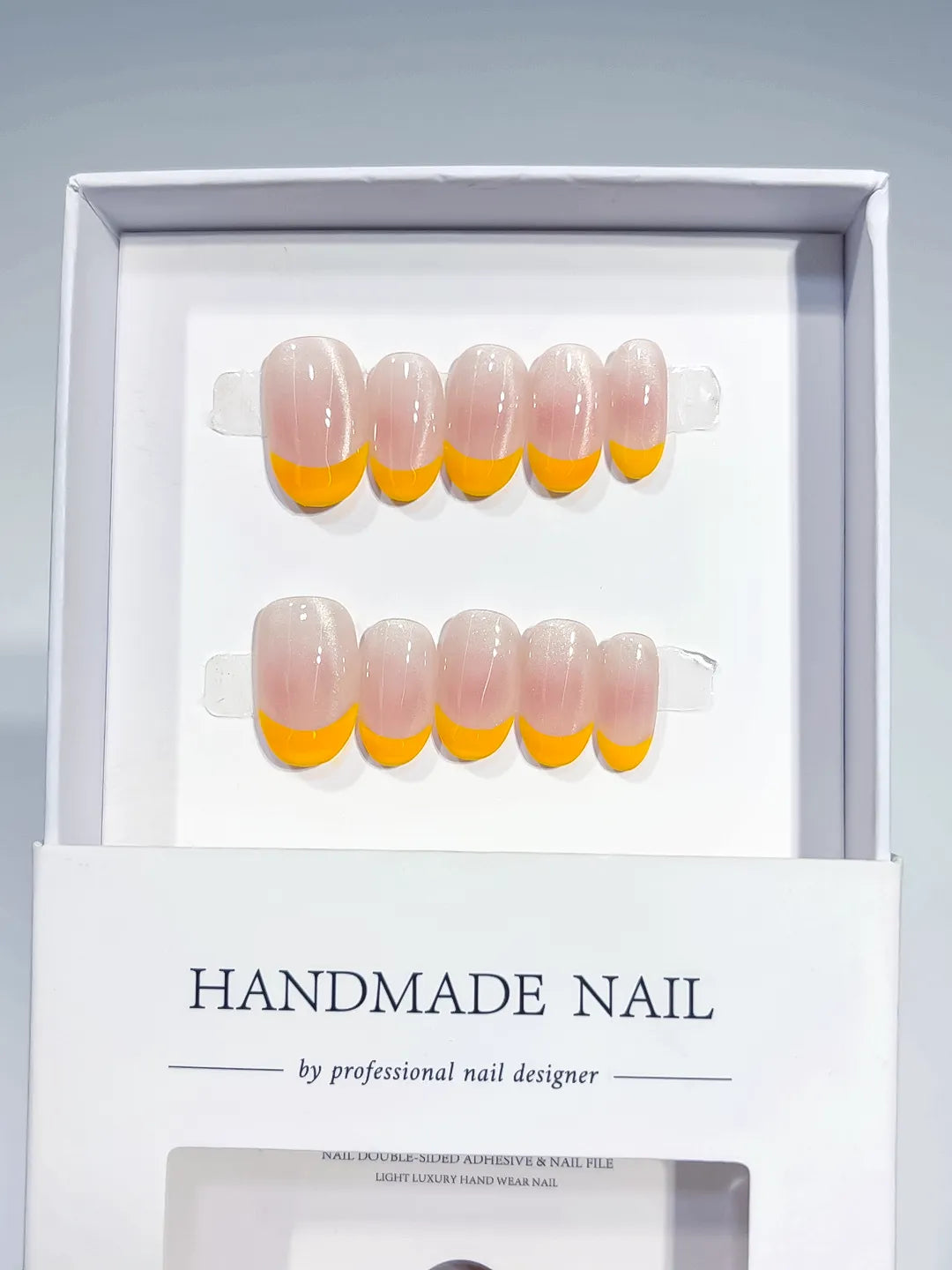 Nude Orange French tip press on nails angled view