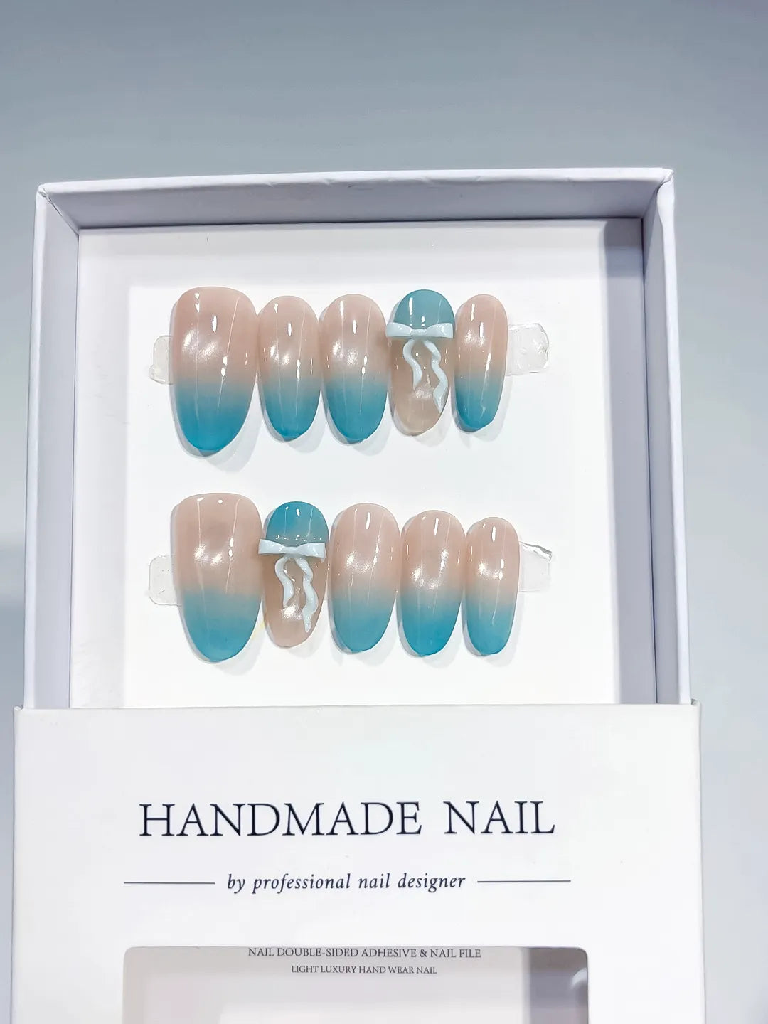 Nude Blue Ombre Bow press on nails angled view