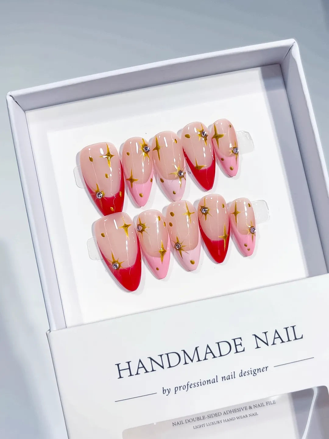 Nude Red Gold French tip Star Rhinestone press on nails angled view
