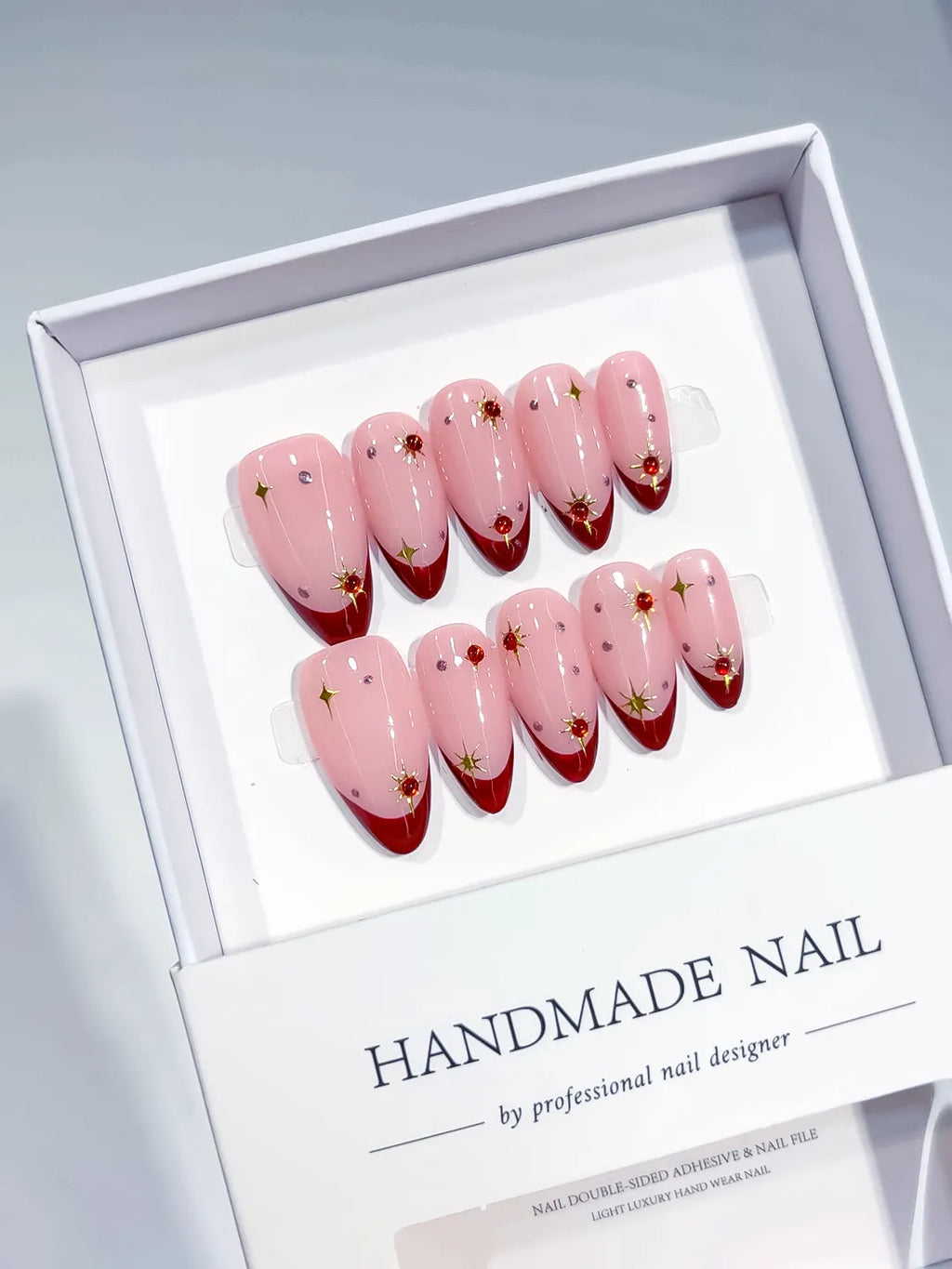 Pink Red Gold French tip Star Rhinestone press on nails angled view