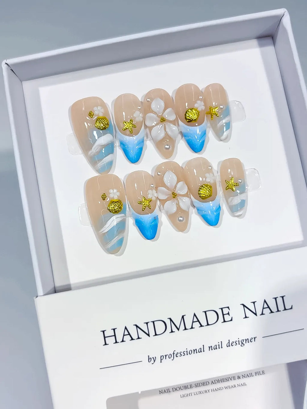 Nude Blue White Gold French tip Flower Star Shell press on nails angled view