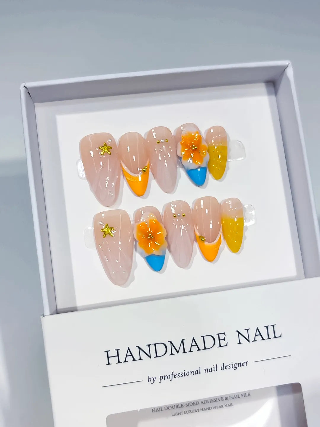 Nude Yellow Orange Blue French tip Flower Star press on nails angled view