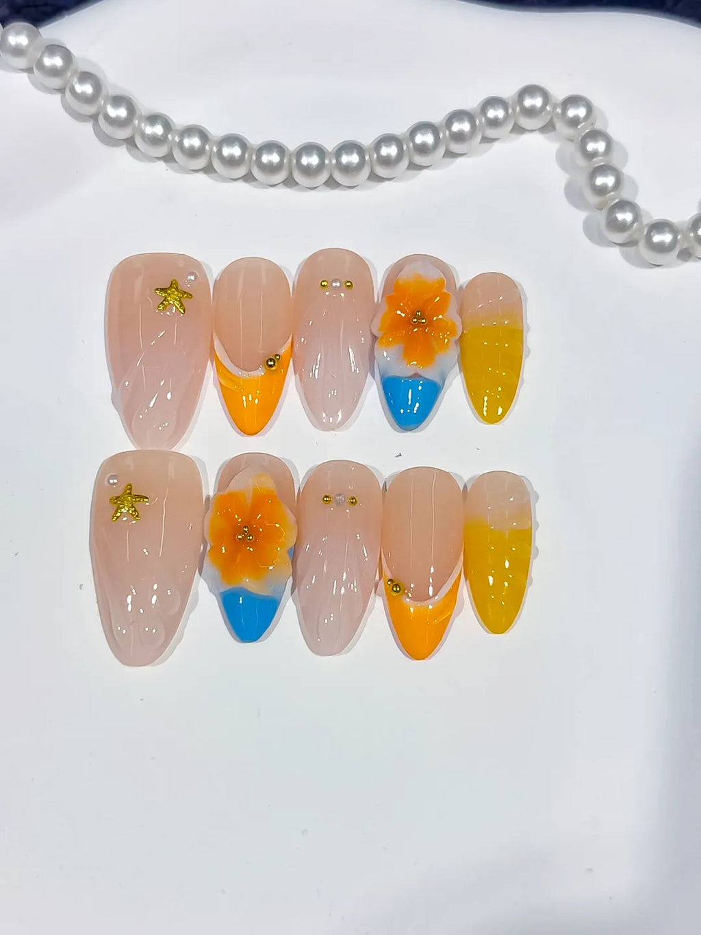Nude Yellow Orange Blue French tip Flower Star press on nails close up