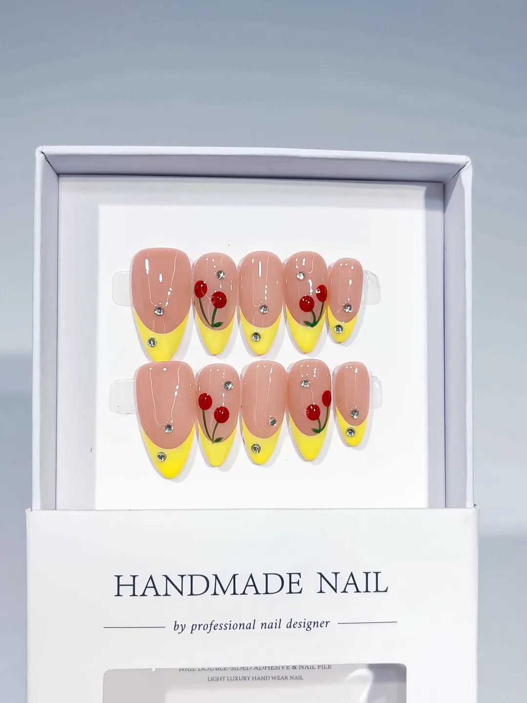 Nude Yellow Red French tip Cherry Rhinestone press on nails angled view