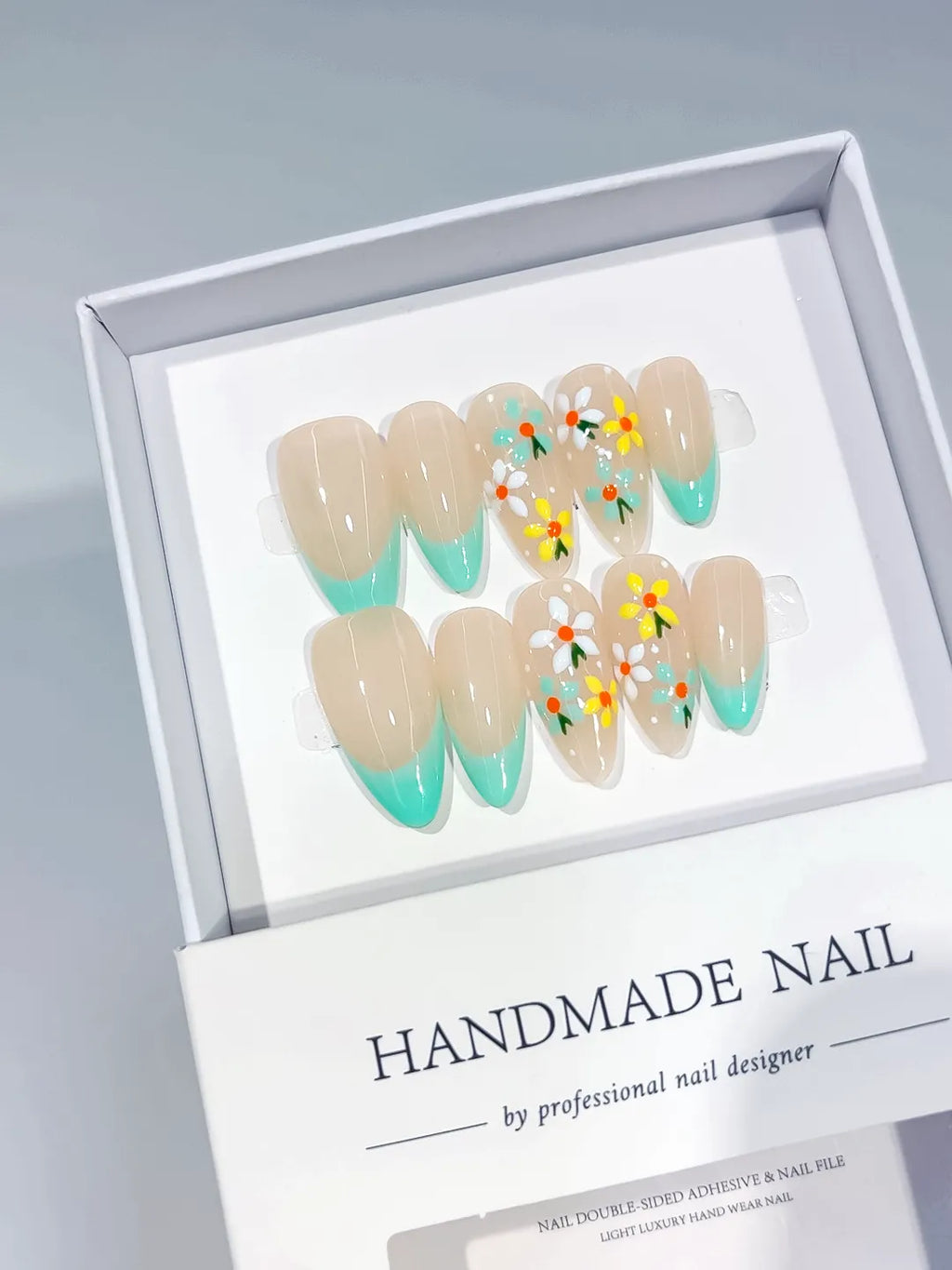 Nude Green Multicolor French tip Daisy press on nails angled view