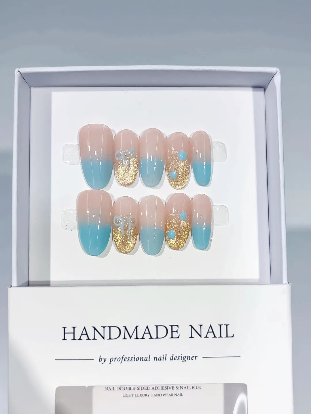 Nude Blue Gold Ombre Glitter Bow press on nails angled view