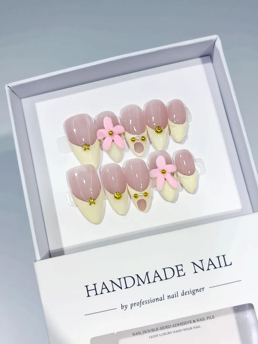 Nude Pink French tip Flower Gold Stud press on nails angled view
