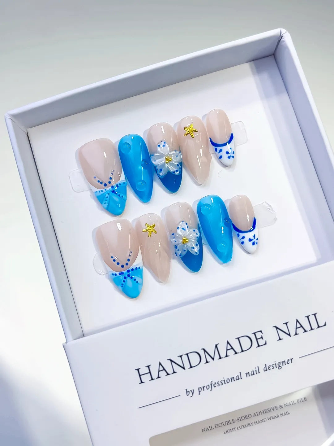 Nude Blue French tip Flower Star press on nails angled view