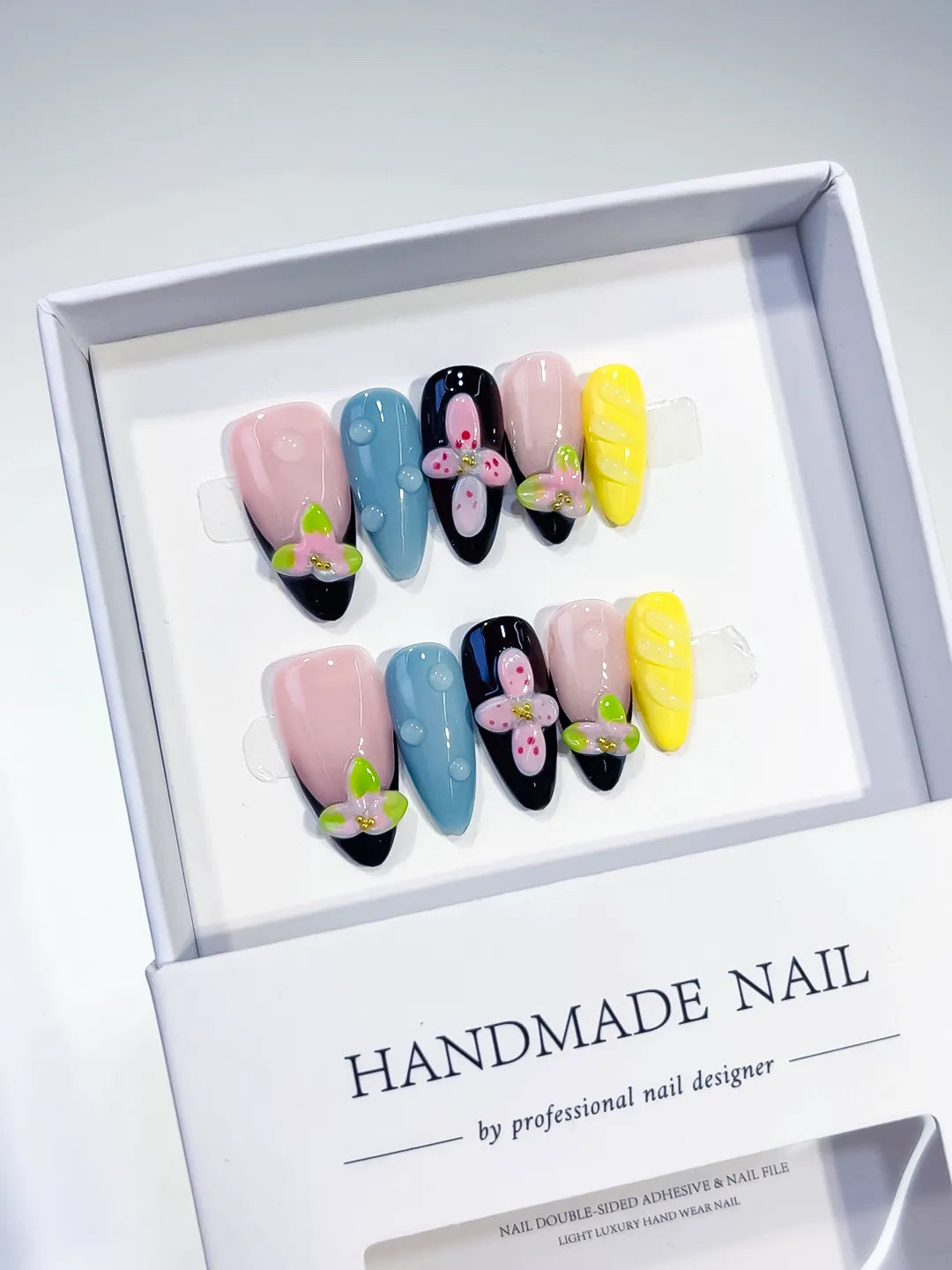 Nude Pink Blue Yellow Black Abstract Flower Embossed press on nails angled view