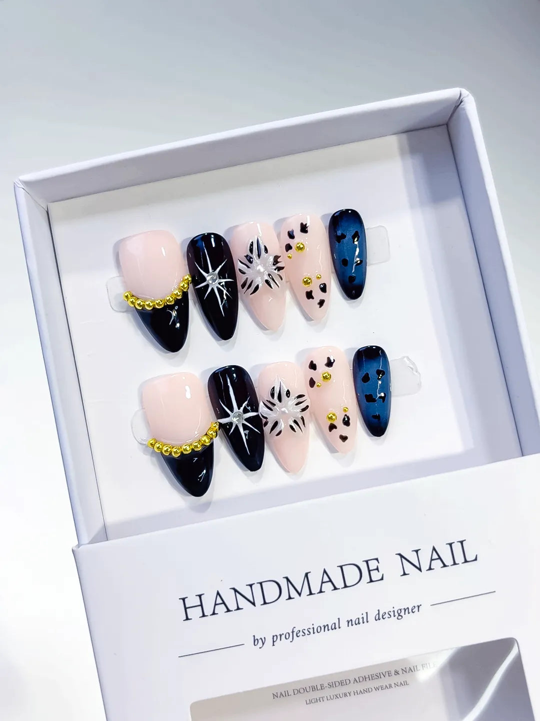 Nude Black Blue Gold French tip Star Animal Print Bead Chain press on nails angled view