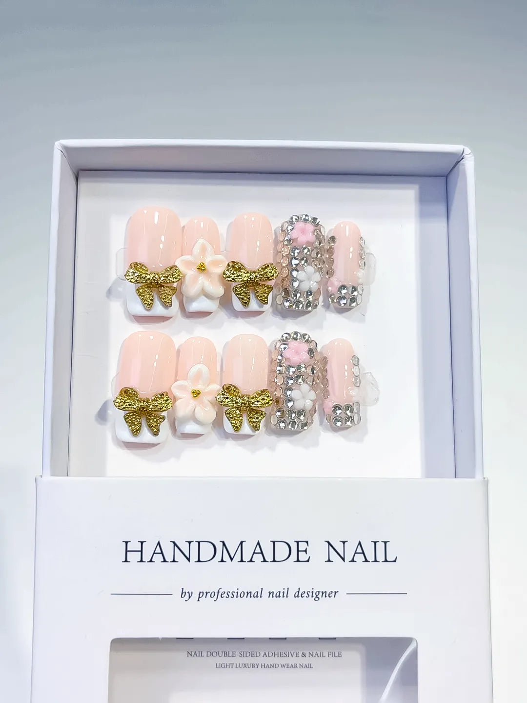 Nude Gold White Glitter Bow Flower Rhinestone press on nails angled view