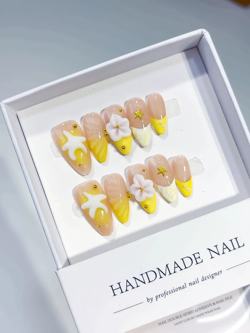 Nude Yellow White French tip Flower Starfish press on nails angled view