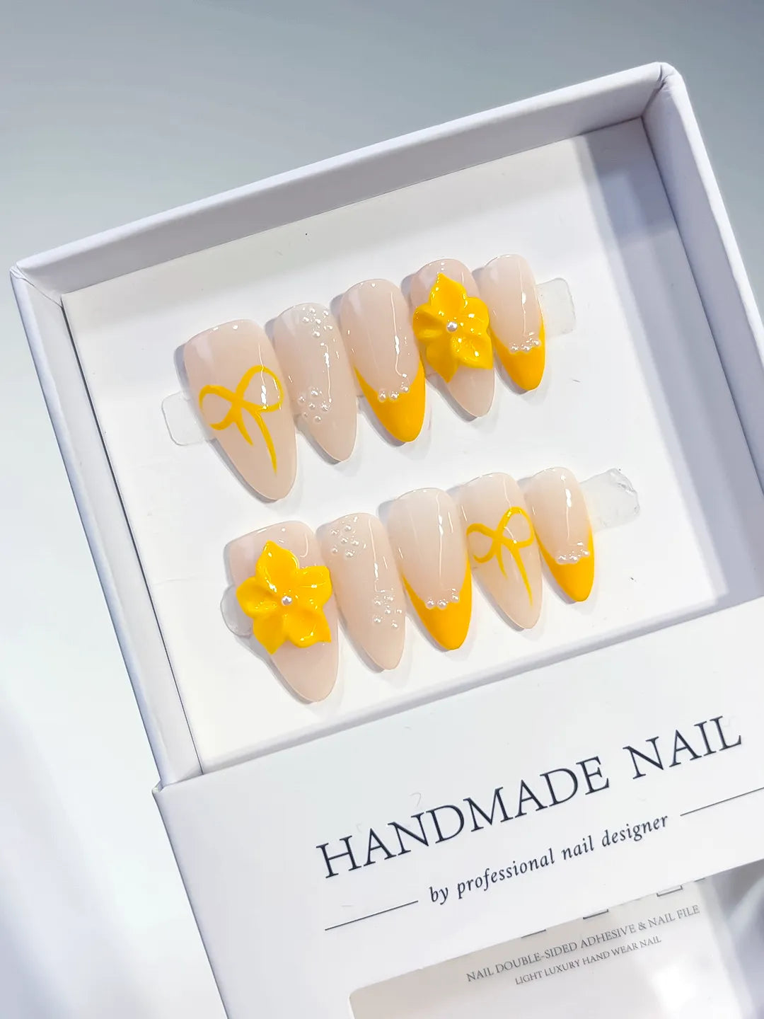 Nude Yellow French tip Flower Bow press on nails angled view