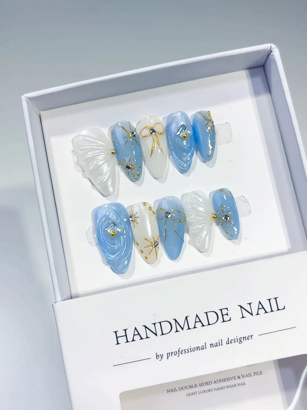 Blue White Holographic Shell Bow Star press on nails angled view
