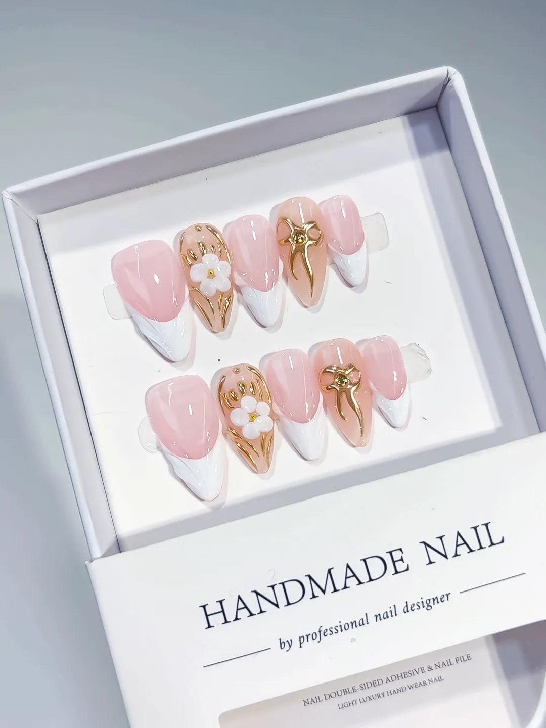 Pink White Gold French tip Flower Bow Metallic Charm press on nails angled view