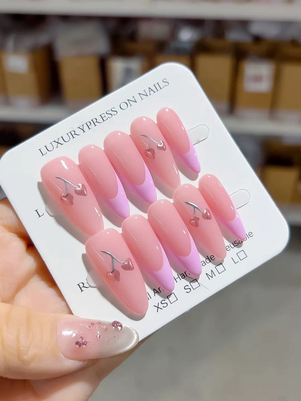 long almond pink french with cherry hearts, handmade press on nails closeup